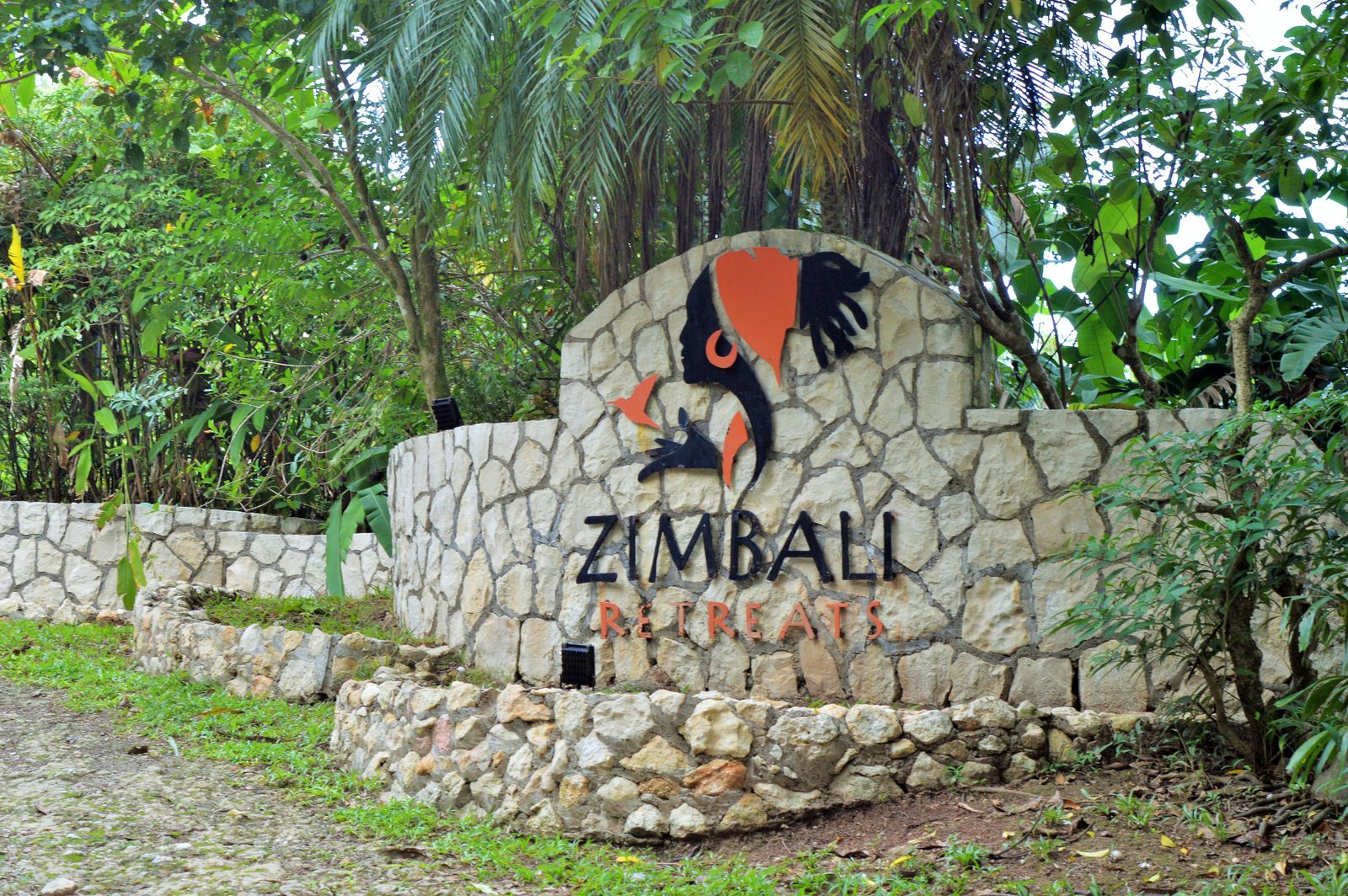 The hand-painted wooden Zimbali Retreats sign in Negril, Jamaica.